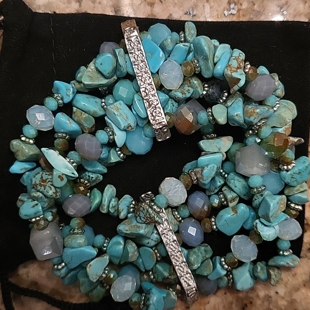 Turquoise and silver tone stretxh multi strand bracelet